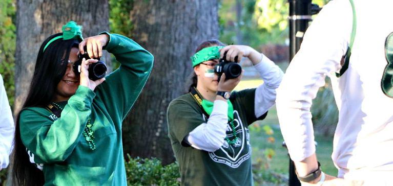 Photography students take photos outside at Chase Collegiate.